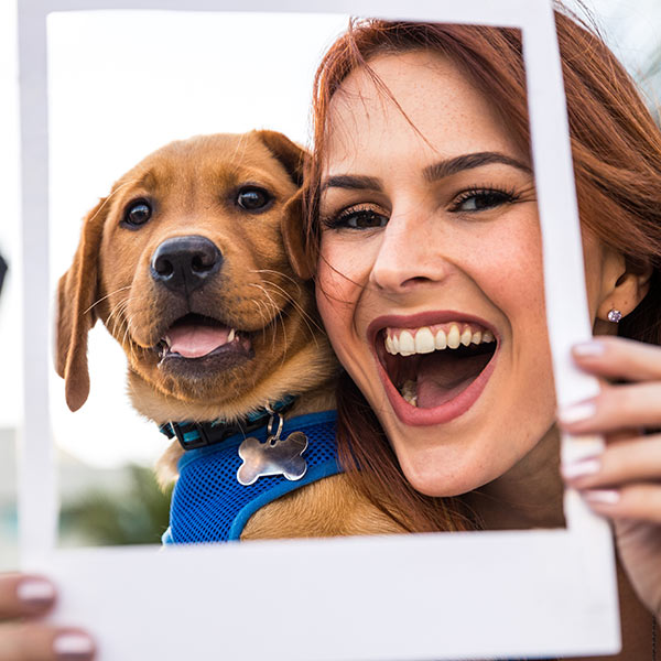 Young woman smiling with her puppy